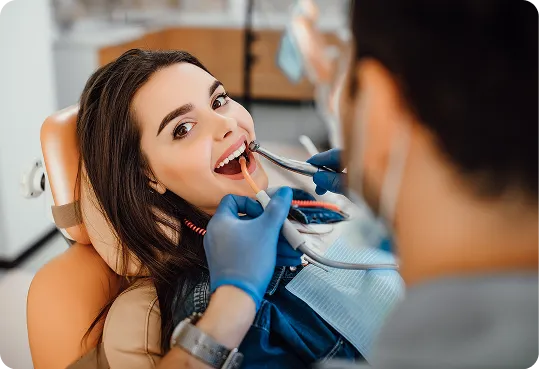 patient receiving a professional dental examination or treatment from a dentist.