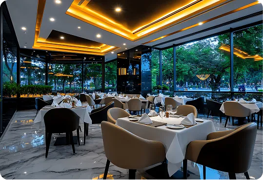large windows overlooking an outdoor area, marble floors, and contemporary lighting on the ceiling.