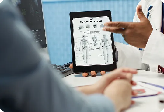 digital tablet displaying an anatomical chart of the human skeleton.