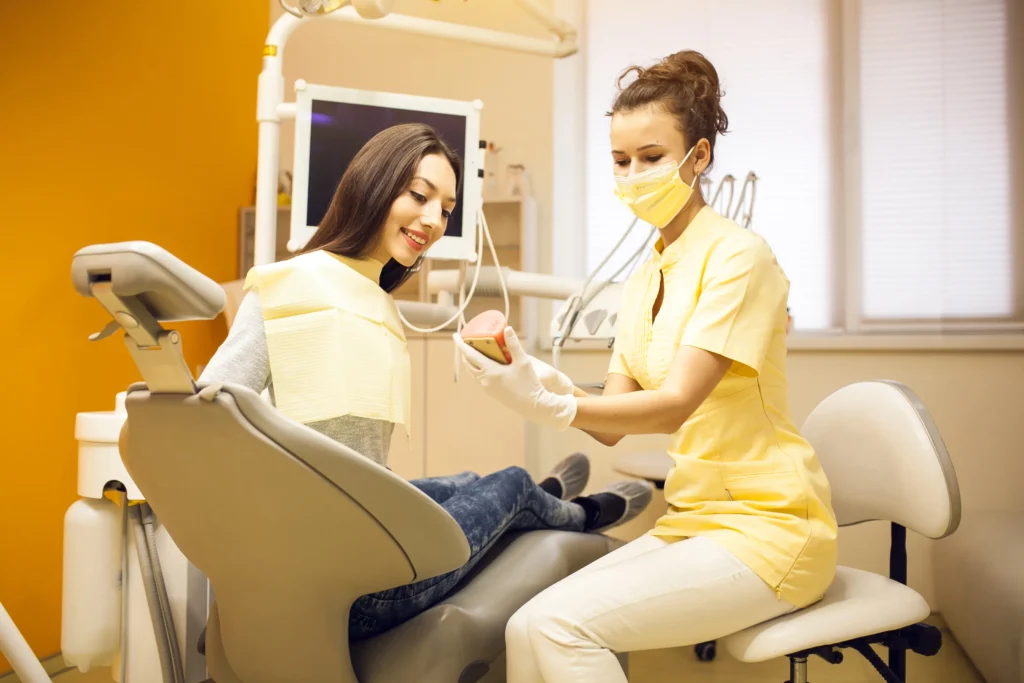 dentist in Brisbane clinic with branded marketing materials graphic design for dental practices
