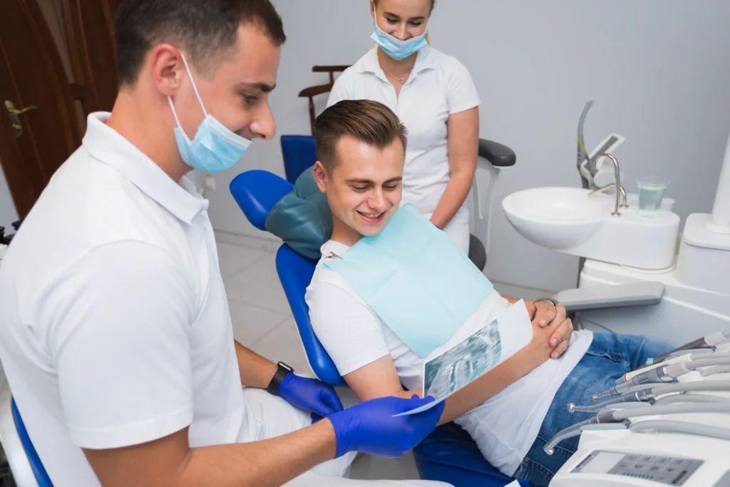 dentist in Adelaide clinic with branded marketing materials graphic design for dental practices