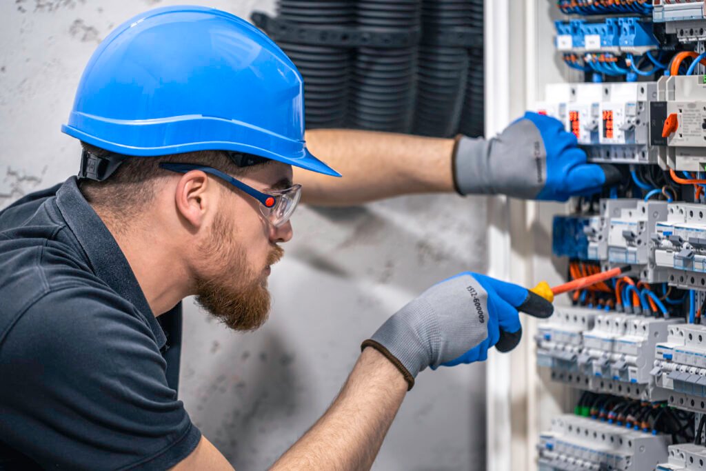 electrician in Melbourne with branded uniform and service van graphic design for electrical business