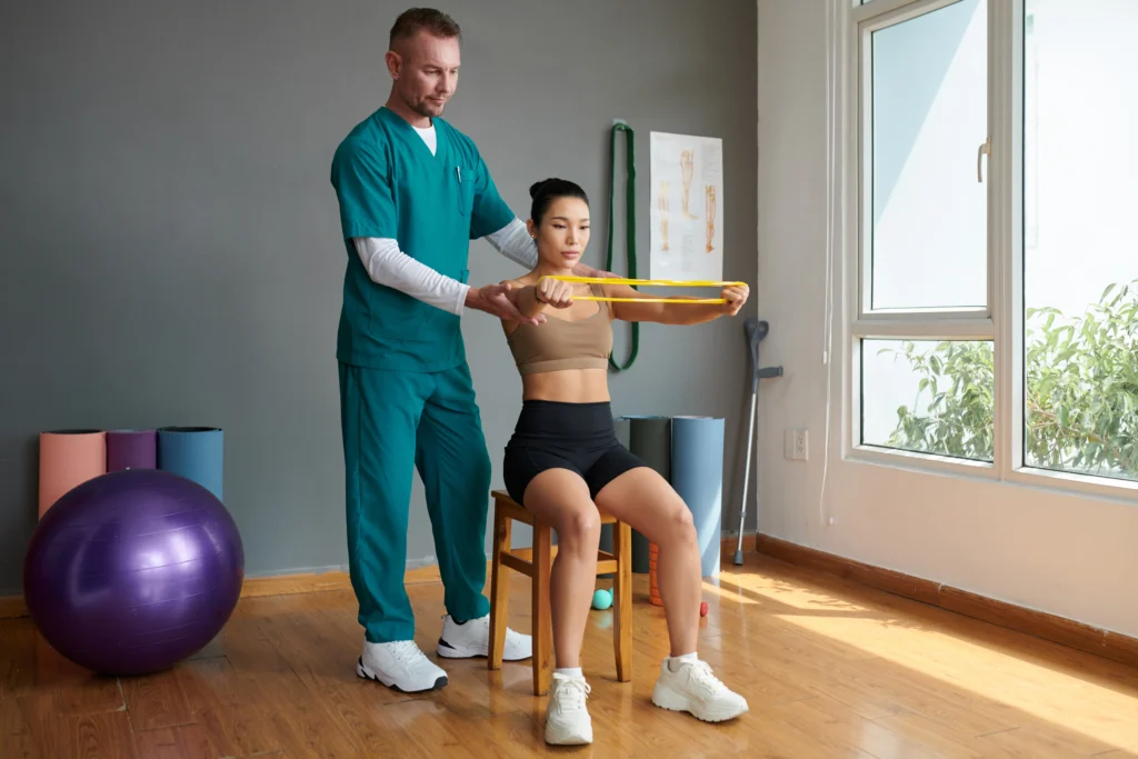 physiotherapist in Hobart clinic with branded brochure and business card graphic design for physiotherapy clinics