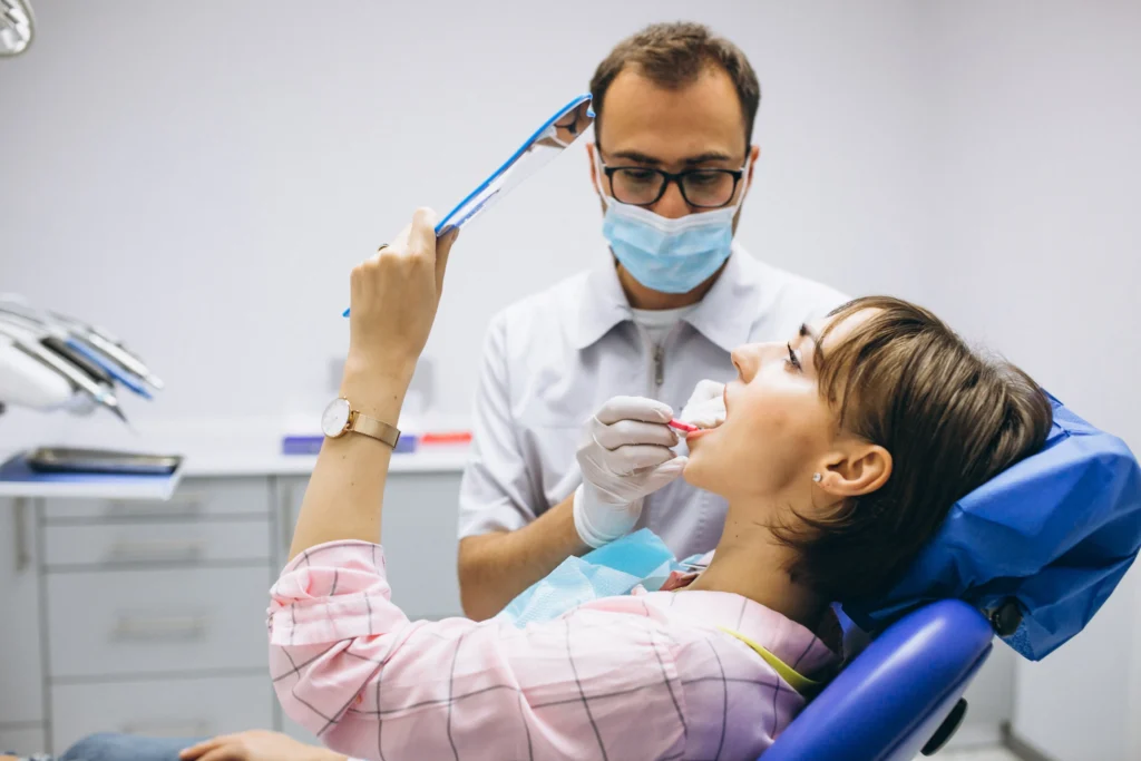 dentist in Melbourne clinic with branded marketing materials graphic design for dental practices